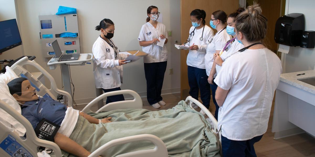 Nursing students in lab instruction.